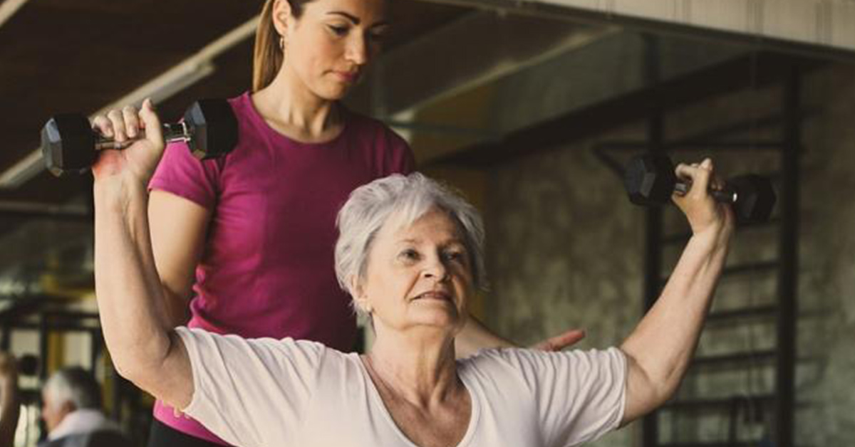 caretaker exercising with elderly woman